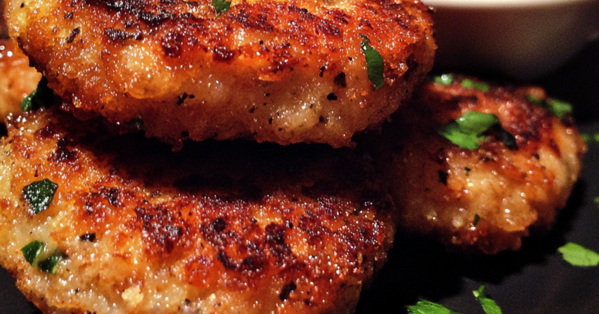 Golden-brown Tyson chicken patties served on a plate with a side of vegetables