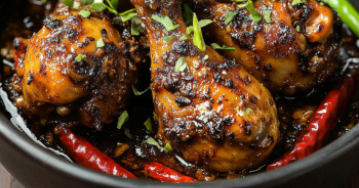 A beautifully prepared black chicken dish featuring tender meat and vibrant herbs, served in a traditional style